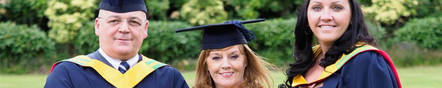 Family pose for photo at Graduation ceremony